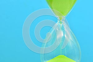 Detail of a green hourglass telling the time
