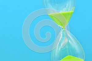 Detail of a green hourglass telling the time