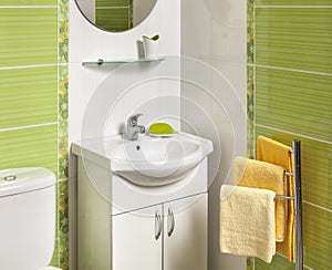 Detail of a green modern bathroom with sink