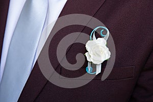 Detail groom wearing floral pins decoration jacket corsage