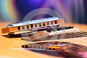 Detail of guitar strings with supported harmonica for country mu