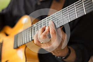Detail of guitarist playing seven string guitar