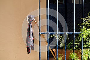 Detail of a gypsy patriarch`s cane on a blue window grille and a black handkerchief with red polka dots attached to the cane.