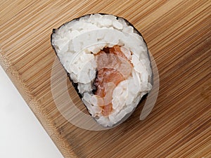 Detail of a half moon maki on a cutting board