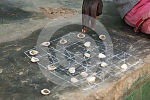 Detail of the hand of a boy playing a game with shells at the village of Eticoga in the island of Orango in Guinea Bissau