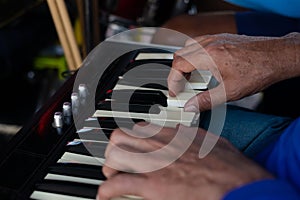 Detail of a hand playing the keyboard at an event