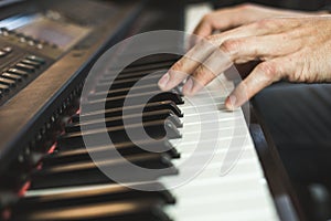 Detail of a hand playing a piano. Pianist concept