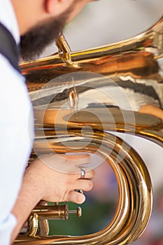 Detail on a hand plays tuba