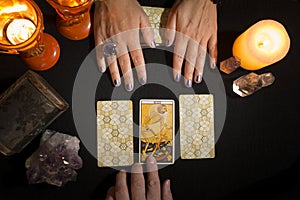 Detail of a hand showing the death card in a tarot session