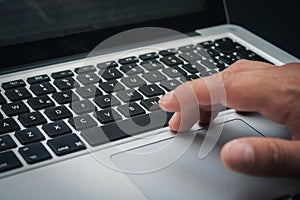 Detail of hands working on computer keyboard