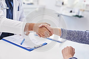 Detail of handshake of doctor and patient in doctor`s office