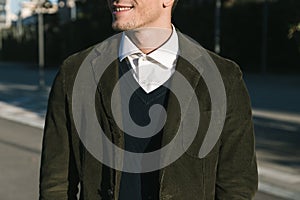 Detail of a handsome man posing in an urban context