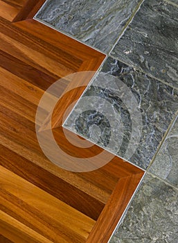 Detail of high quality wood and stone tile floor in contemporary upscale home interior