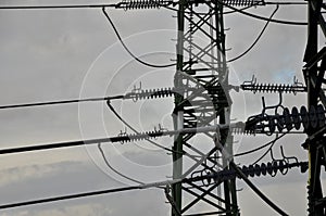 Detail of high voltage wire attachment with insulators made of porcelain plates. Slack wire connection and metal sleeve connection