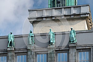 Detail horizontal shot of four statues on the top of Ostrava New City Hall. Industrial style architecture.