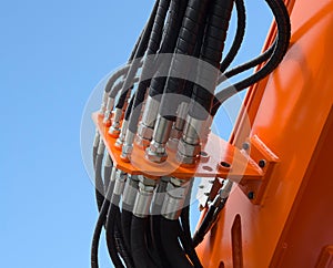 Detail of hydraulic bulldozer piston excavator arm against blue sky