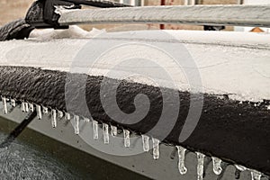 Detail of icy car body and window visor after freezing rain