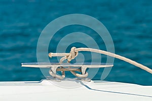 Detail image of yacht rope cleat on sailboat deck