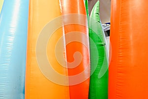Detail of inflatable castles with shapes of flames of giant colors