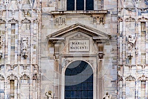 Detail of the inscription, `Mariae Nascenti.` over the central window of the Duomo di Milano.