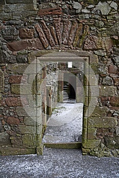 Detail from inside ruined Balvaird Castle in Scotland showing doorway, passageway and spiral stone staircase