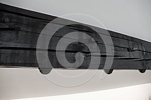 Detail of an interior wooden beam in ceiling