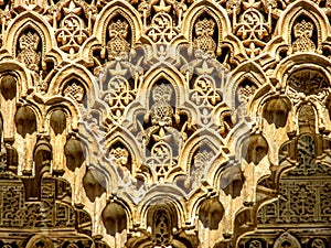 Detail of the intricate patterns on a wall of the Alhambra Palace in Granada, Spain.