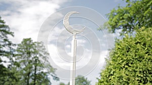 Detail of the iron fence - crescent moon symbol in a garden next to islamic mosque