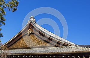 Detail on japanese temple roof against blue sky