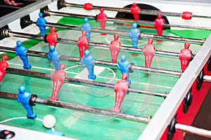 Detail of kid`s hands playing the foosball table match. Soccer game, friends recreation