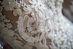 detail of lace and pearls on a wedding dress