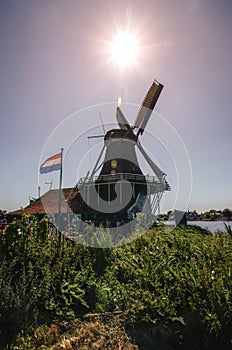 Detail of a large Dutch mill with a flag in Holland.