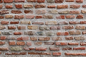 Detail of a large section of a red, brick wall worn down by time