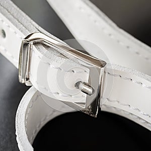 Detail of leather handbag, white strap with silwer metallic buckle photo