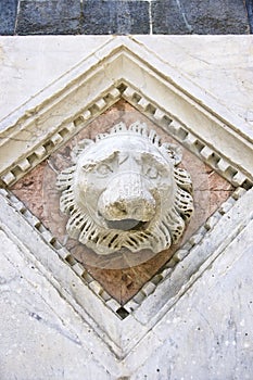 Detail of a lion head relive of the facade of the cathedral of Florence, Tuscany