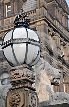 Detail of lion sculpture and ornate lamp outside teeds town hall