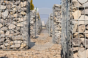 Detail of a low gabion wall. The texture of the gabion fence is made of natural stone