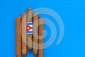 Detail of luxury Cuban cigars on the blue table