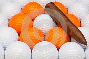 Detail of luxury Cuban cigars on the golf balls photo