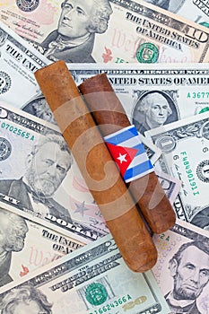 Detail of luxury Cuban cigars on the US dollars photo