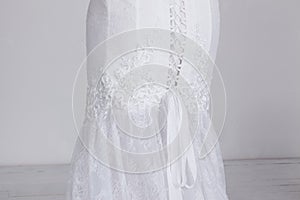 Detail of luxury expensive wedding dress. Lace, satin ribbons, expensive fabric.