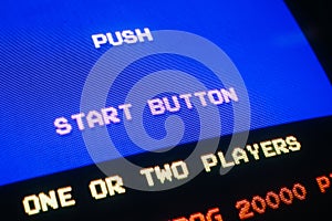 Detail Macro of an old vintage video game with text Push start button photo