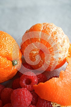 Detail Macro of a Whole Oranges with Raspberries