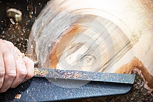 Detail macro of wood turning with flying sawdust shavings