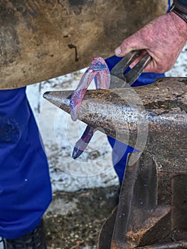 Detail of making new horseshoe in blacksmith workshop