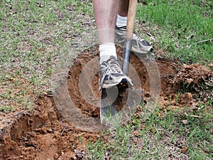 A detail of a man digging