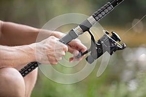 detail man hand on fishing pole