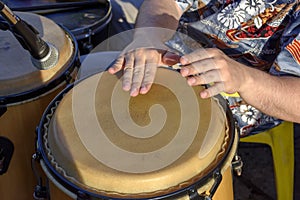 Detail of man playing atabaque during party at the carnival