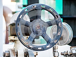 Detail of a manual valve with black steering wheel photo