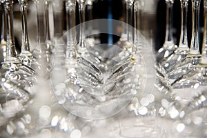 Detail of many clear and clean glass glasses arranged on the table of a bar to serve wine